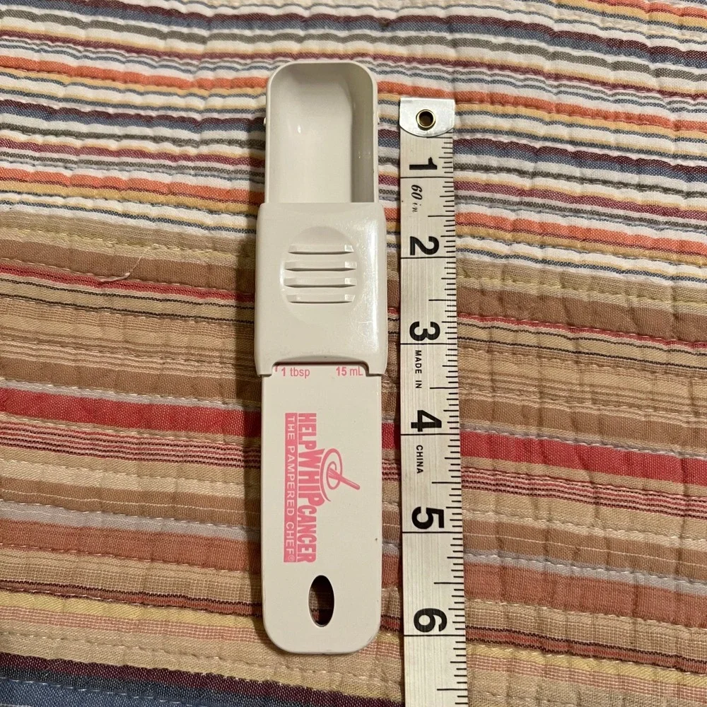 The Pampered Chef Help Whip Cancer Adjustable Measuring Spoon White Pink